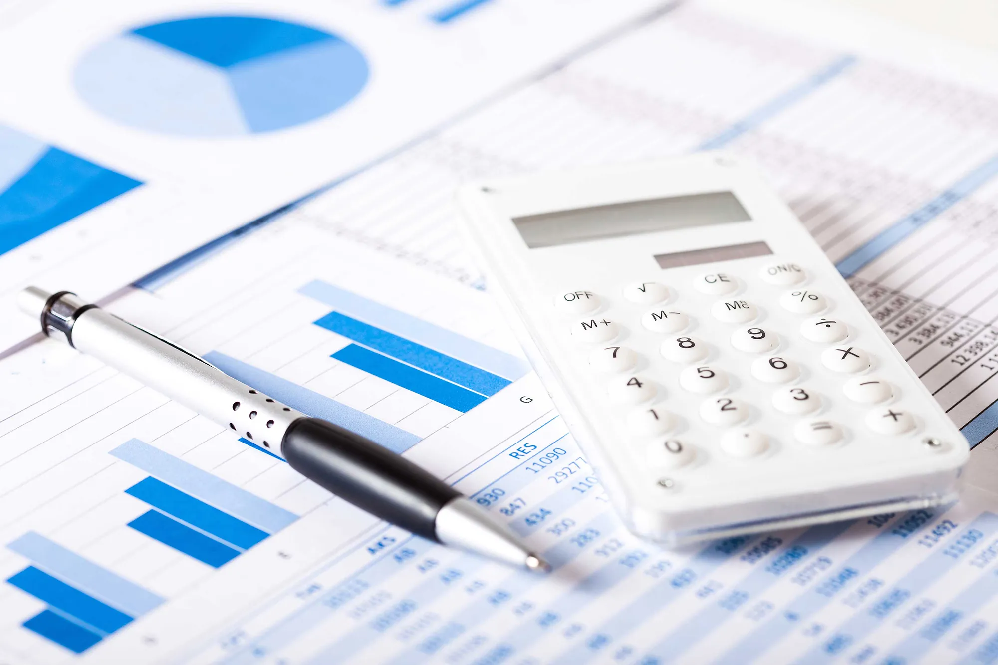 Financial charts and calculator on a desk