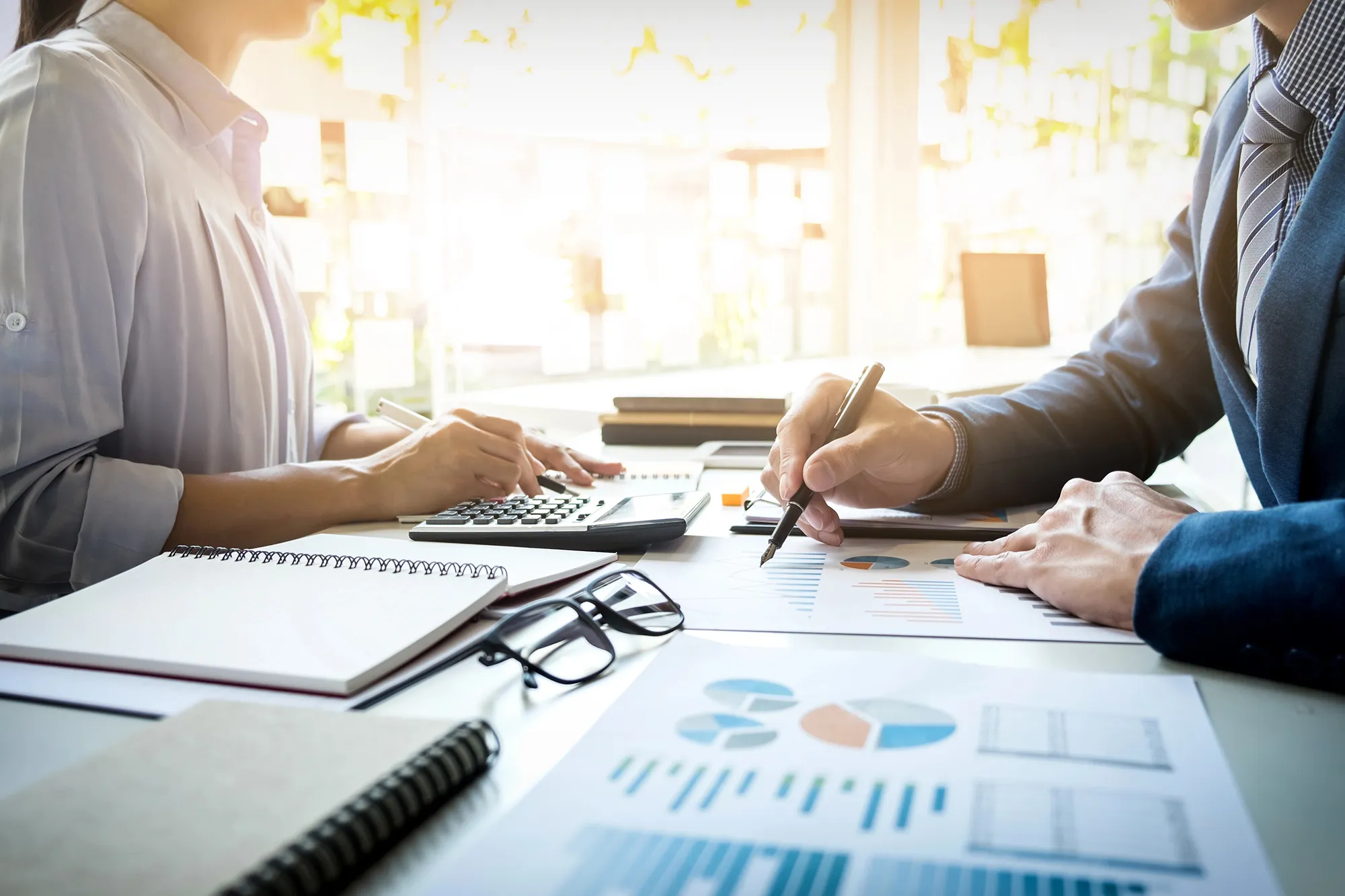 Two business owners reviewing financial charts