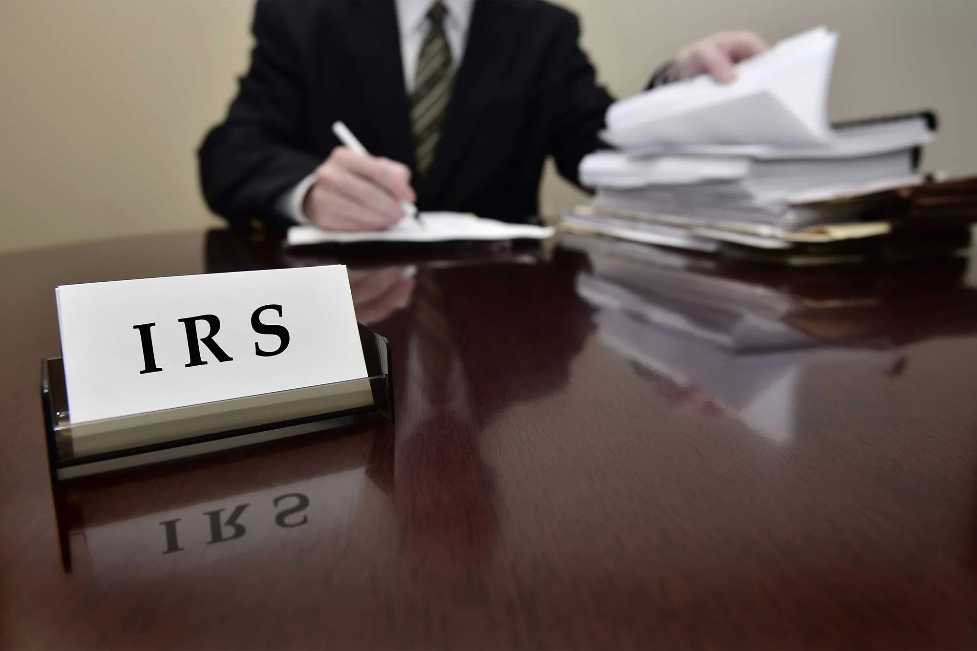 IRS nameplate on a desk with paperwork
