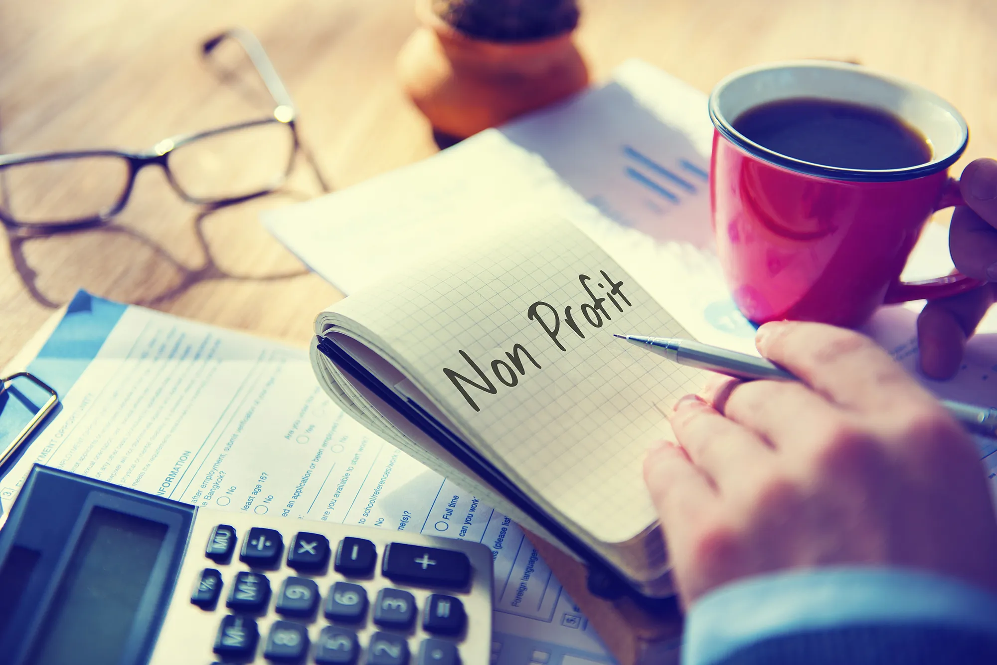 Notebook labeled Non Profit alongside financial charts